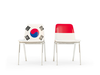 Two chairs with flags of South Korea and indonesia isolated on white