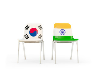 Two chairs with flags of South Korea and india isolated on white
