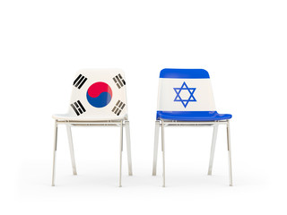 Two chairs with flags of South Korea and israel isolated on white