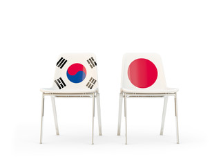 Two chairs with flags of South Korea and japan isolated on white