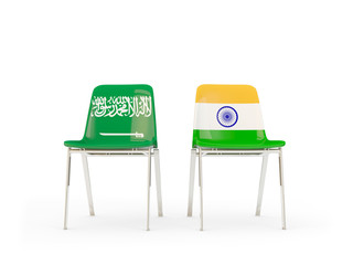 Two chairs with flags of Saudi Arabia and india isolated on white