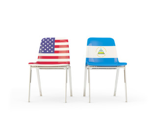 Two chairs with flags of United States and nicaragua isolated on white