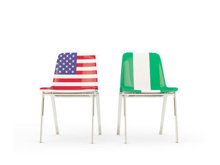 Two chairs with flags of United States and nigeria isolated on white
