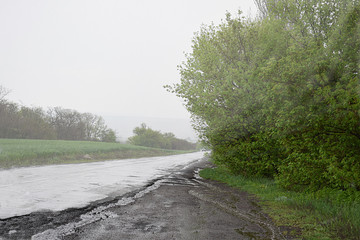 Landscape with a road during a rainstorm.
