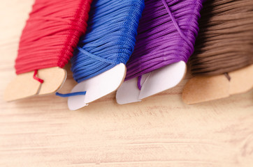Fototapeta na wymiar colorful stacking cotton yarn wool over beautiful reverberation gradient background.