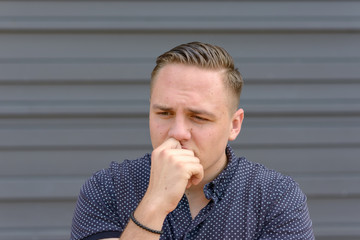 Anxious worried young man frowning
