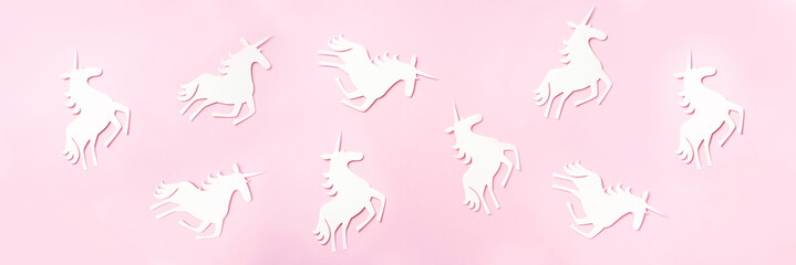 Creative unicorn pattern on pink background. Abstract art texture Minimal fantasy concept. Banner. Top view