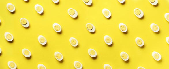 Food concept with boiled eggs pattern on yellow background. Top view. Creative pattern in minimal style. Flat lay. Banner