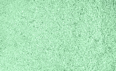 Top shot of trendy mint colored Pebble beach texture. Neutral monochrome nature background