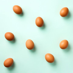 Food concept with chicken eggs on blue background. Top view. Creative pattern in minimal style. Flat lay. Square crop