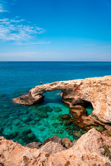 Beautiful turquoise clean water and blue sky in famous touristic Ayia Napa, Paralimni, Cyprus on a sunny day with amazing rock formations  and cliffs.