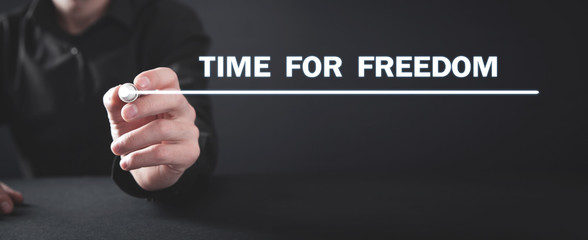 Man writing Time For Freedom text on screen.