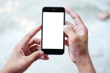 Cropped shot view of man hands holding smart phone with blank copy space screen for your text message or information content, female reading text message on cell telephone during in urban setting.
