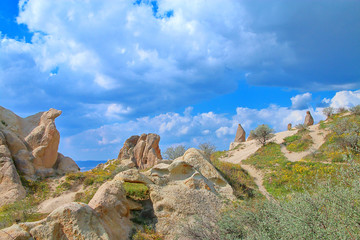 Picturesque slopes of the mountains of Cappadocia under the bright clouds.
