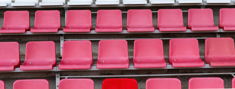 Stadium Seats, One Seat Stands Out In Red Color. Soccer, Football Or Baseball Stadium Tribune Without Fans.