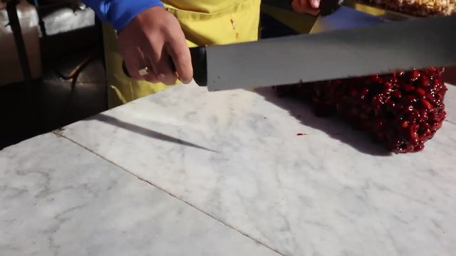 Torrone Siciliano - traditional Sicilian brittle made of almond and caramel  street food with typical sweets with almonds preparation made at the moment. typical dessert from Sicily preparation made a