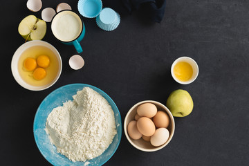 Baking ingredients for cooking homemade apple pie on black background top view