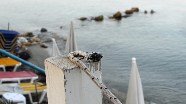 wooden pillars connected with white rope marking the end of the terace