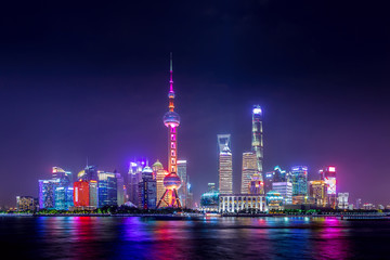 Cityscape of Shanghai at twilight sunset. Panoramic view of Pudong business district skyline from the Bund.