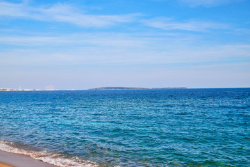 Sea, blue sky, white clouds and wave on a Sunny day