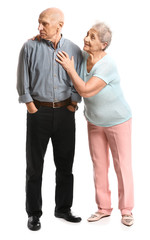 Senior woman and her offended husband on white background