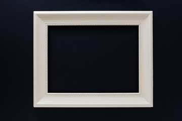 White retro old picture frame, on black background.