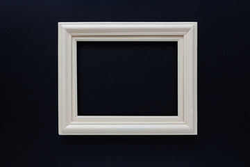 White retro old picture frame, on black background.