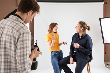 Makeup artist, model and photographer in modern studio