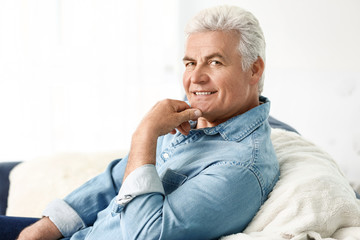 Portrait of handsome senior man at home