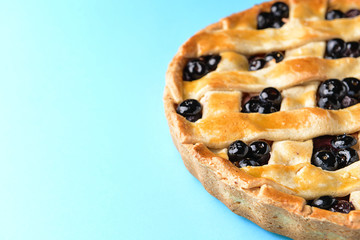 Tasty blueberry pie on color background