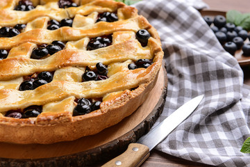 Tasty blueberry pie on table