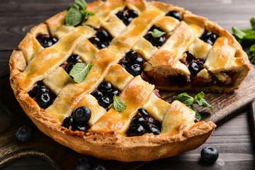 Tasty blueberry pie on wooden table