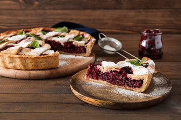 Tasty cherry pie on wooden table