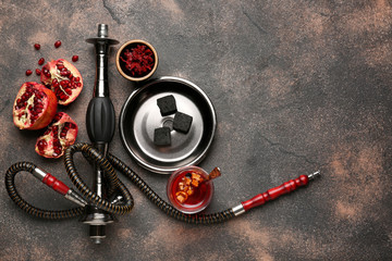 Parts of hookah and pomegranate on grunge background