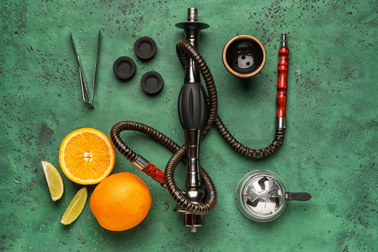 Parts of hookah and fruits on color background