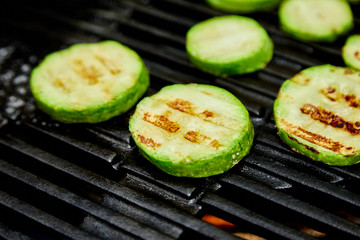 Grilled zucchini vegetable on huge gas grill . Vegan food. Diet, healthy Picnic. Summer. Top view. Flat lay. Copy space..