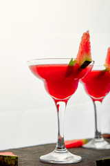 Watermelon margarita cocktail on black background. Fresh watermelon lemonade