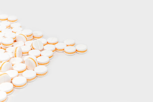 White pills, painkillers on a white background. Concept healthcare and medicine.