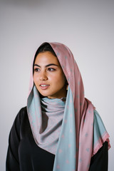 Studio portrait of a beautiful, young and attractive Middle Eastern woman in a traditional black...