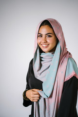 Studio portrait of a beautiful, young and attractive Malay Asian woman in a traditional black dress...