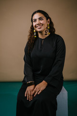 Studio portrait of a beautiful, young and attractive Malay Asian woman in a traditional black dress...