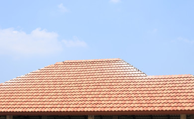 tiles roof on new house with blue sky