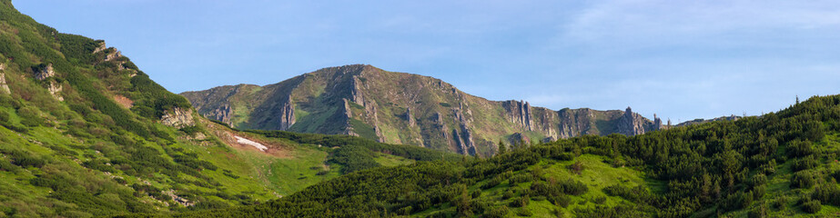 Mountain ridge with rocky outcrops in Carpathian Mountains, panoramic view