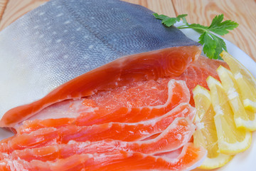 Partly sliced salted arctic char on a dish close-up