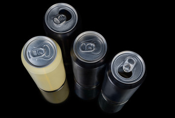Different sealed and open beverage cans on a black background