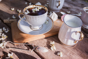 still life - cups of tea, meringues and flowers