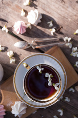 Obraz na płótnie Canvas still life - cups of tea, meringues and flowers
