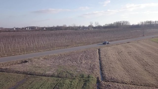 Car driving on spring country road.