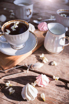 still life - cups of tea, meringues and flowers