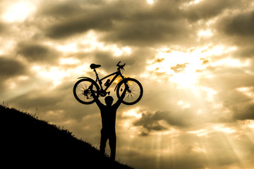 Fototapeta na wymiar Cyclist man silhouette and mountain bike.